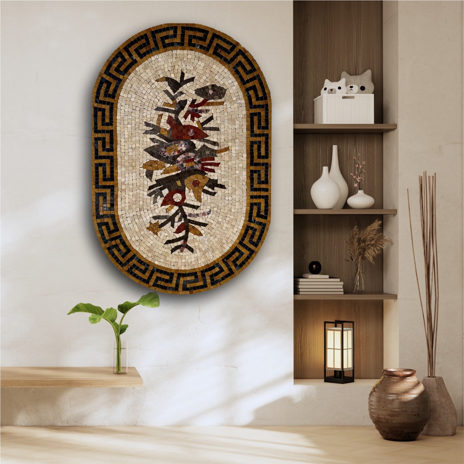 A floral patterned wall hanging artwork in a geometric frame, displayed on a wall above a bench with a cat statue, next to a shelf with books and a plant.