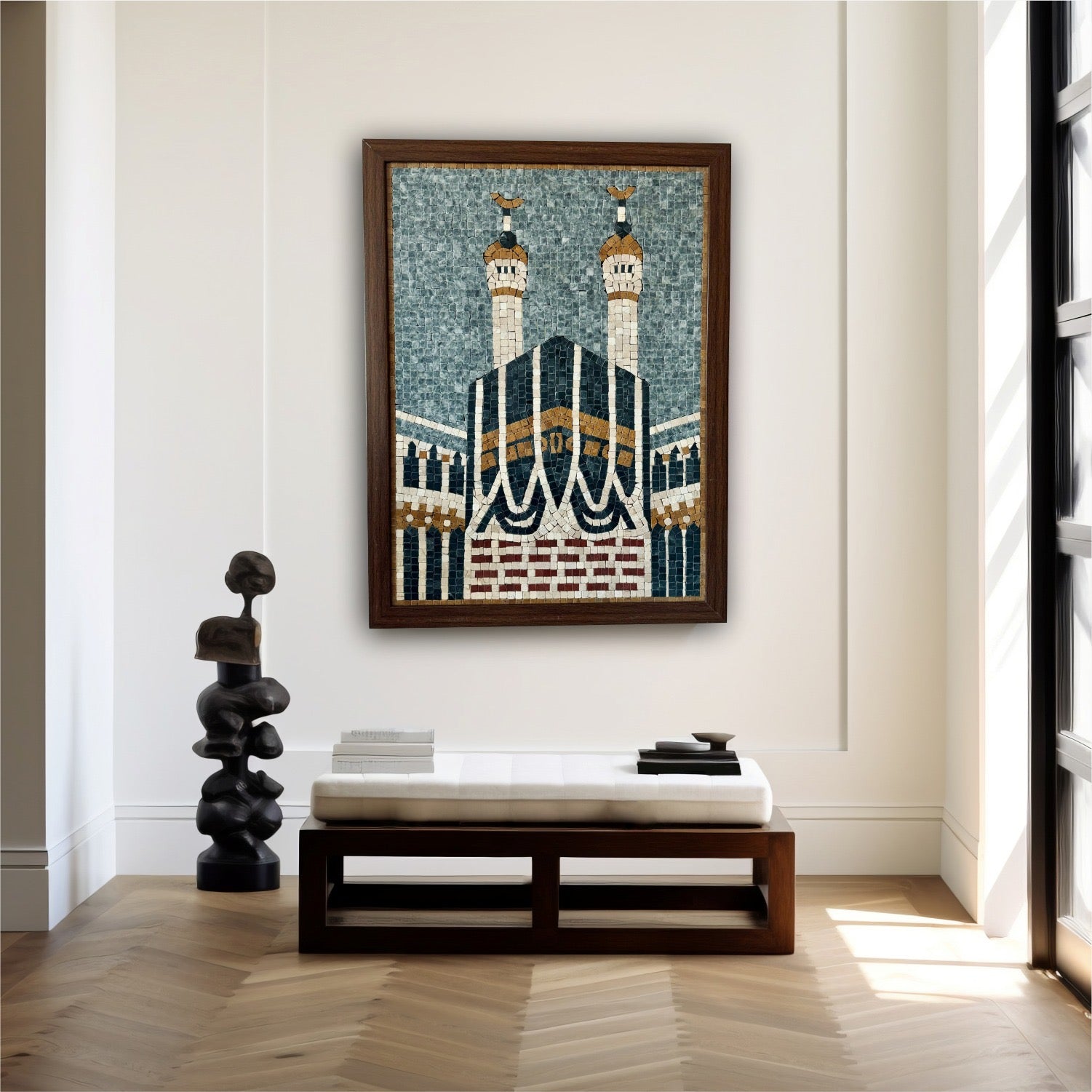 A stone wall hanging depicting the Khana Kaaba with intricate designs, displayed over a bench in a bright room.